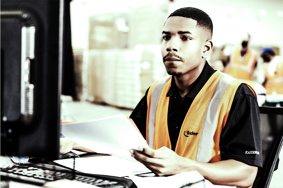 contract assembly employee working on a computer