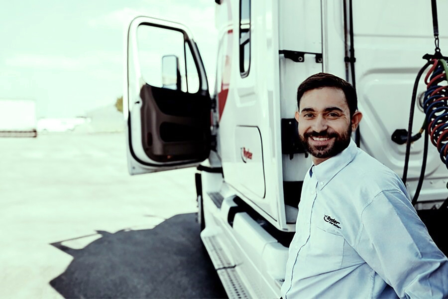 driver next to a commercial truck