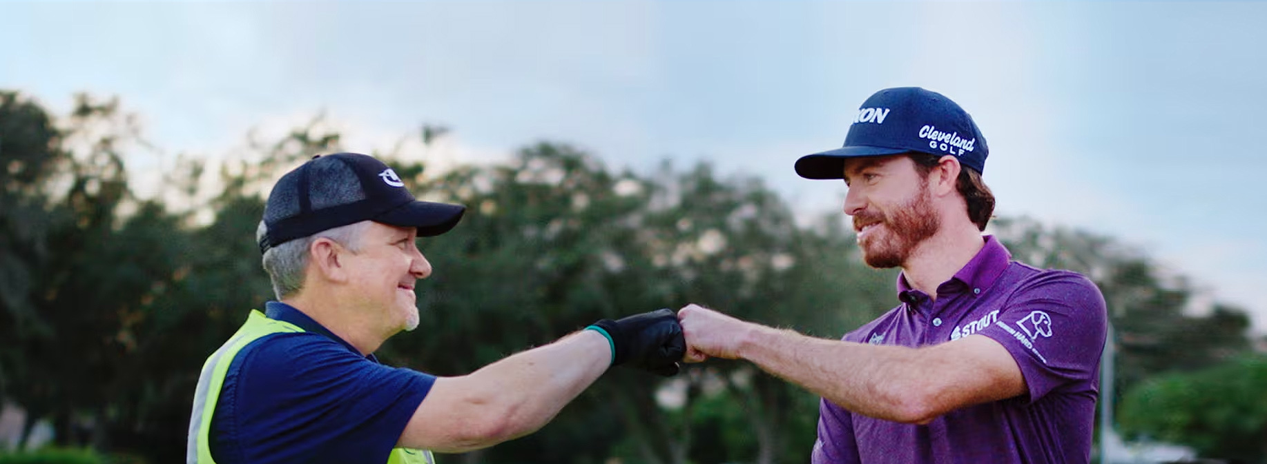 golf pro Sam Ryder fist bumping Ryder truck driver